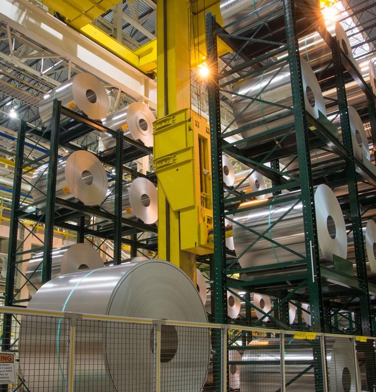 A stacked racking system holds several large metal coils.