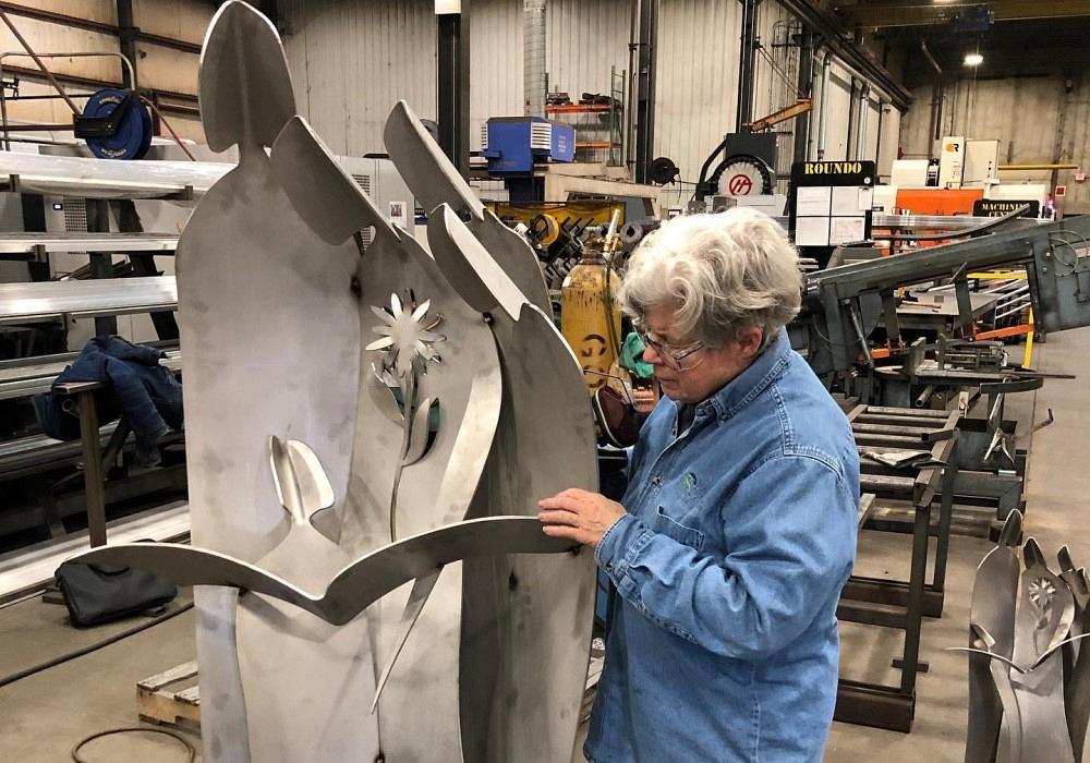 Metal artist from Iowa in her shop