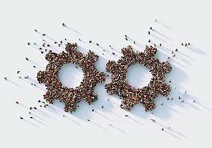 Human crowd forming two gear symbols on gray background. 