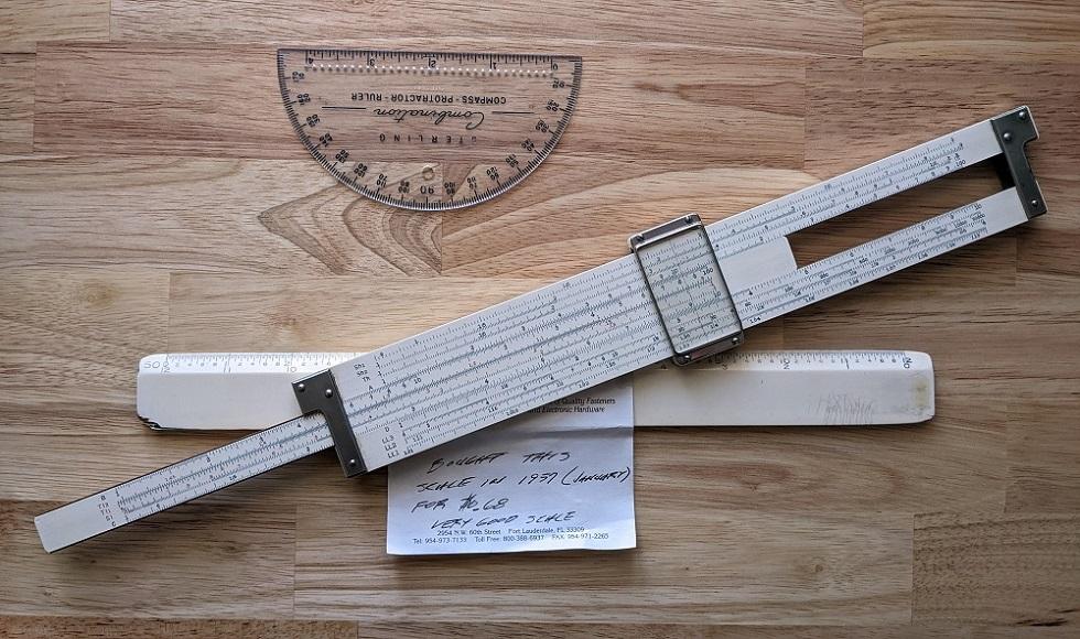 A slide rule, a protractor, and an old scale