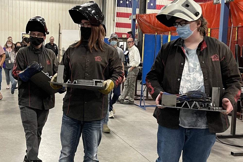 Students collect their final weld projects.
