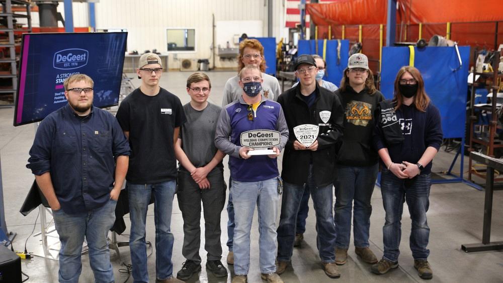 Welders pose with their team trophy.