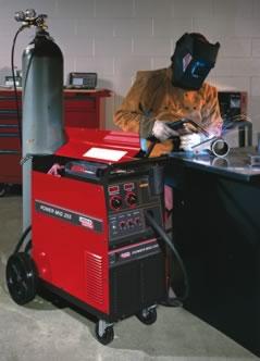 Man welding with Lincoln Electric power source.