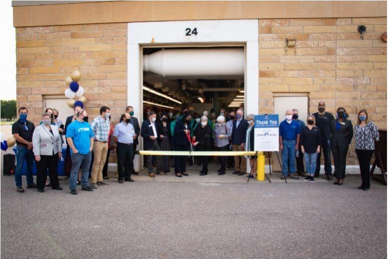 A group celebrates the grand opening of the remodeled welding lab at South Central College. 