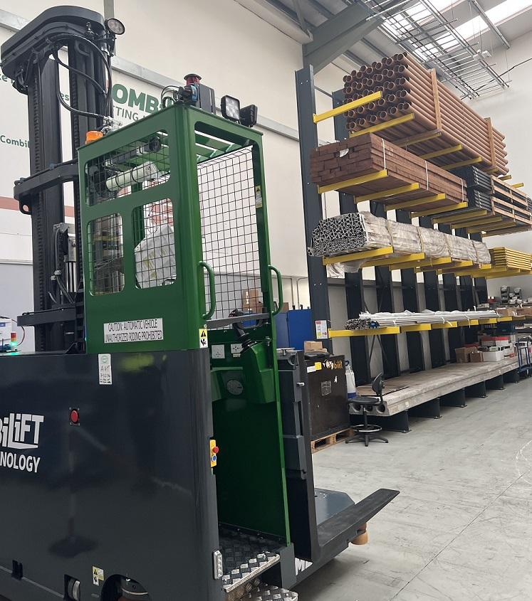 An automated forklift moves about in a factory.
