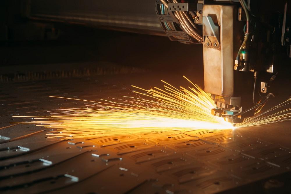 Laser cutting machine cuts the metal with sparks 