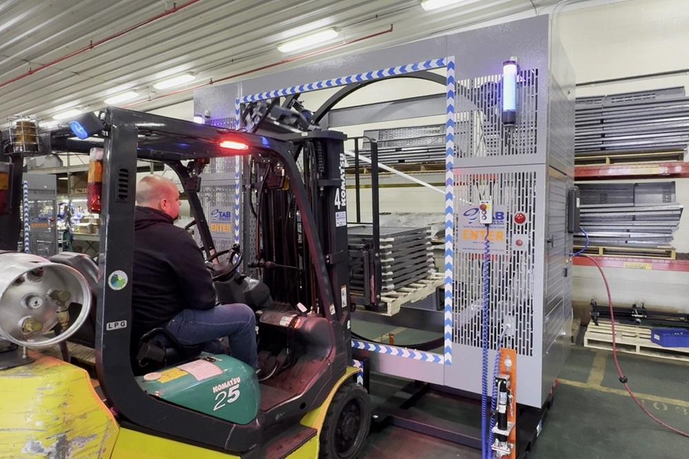 A forklift approaches an orbital wrapper