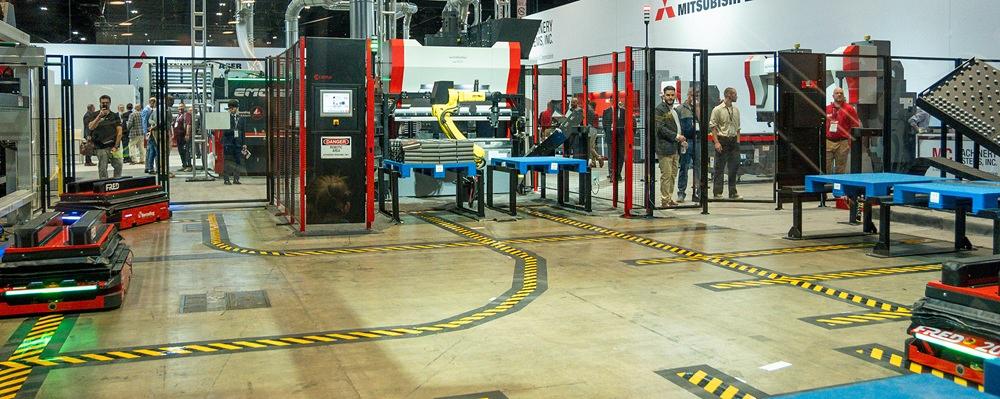 AGVs move on a track around a factory floor.