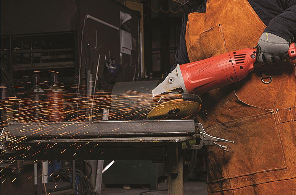 A right-angle grinder is used to finish a metal tube.