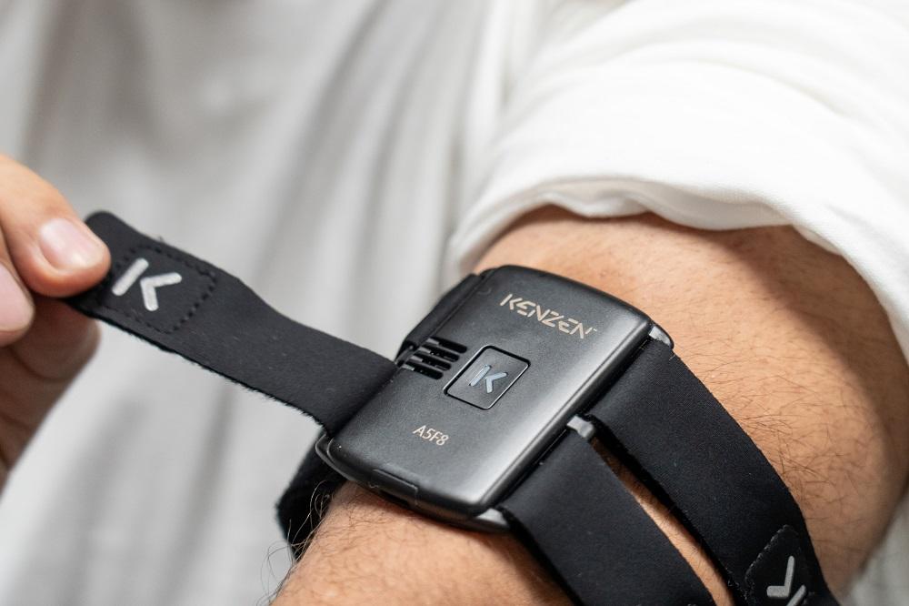 A person wears a device on their arm.