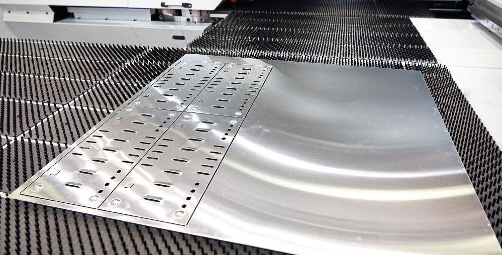 A punching machine makes hole in sheet metal.