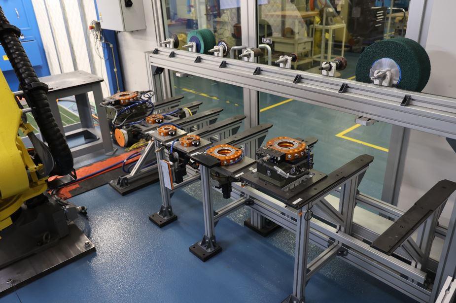 A rack of end-of-arm tooling for robots is shown.