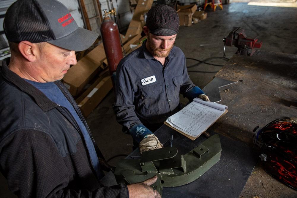 Metal fabricators going over a job