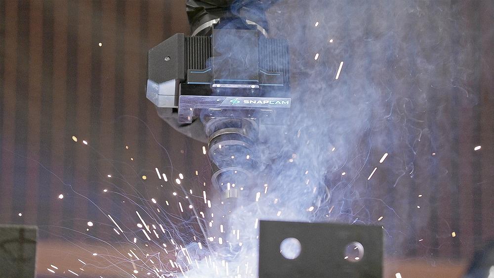 A robot welds metal.