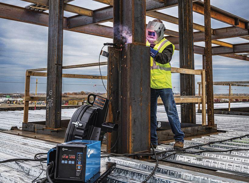 A welder on a construction site using shielded metal arc welding (SMAW)