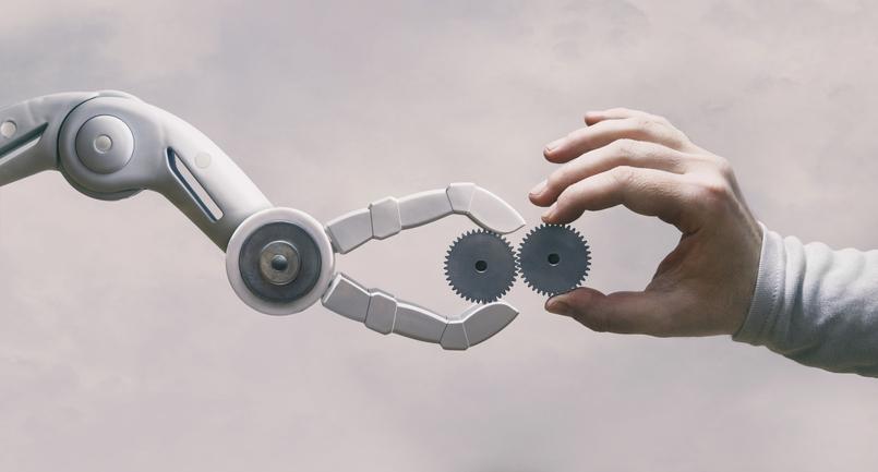 A robot gripper and a human hand touch.