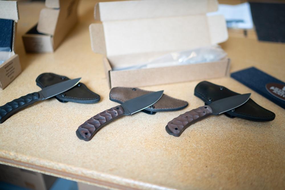 Three knives from Winkler Knives are displayed on a table.