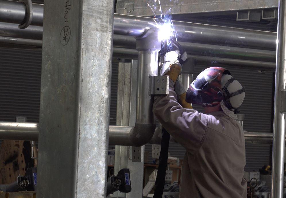 A welder works in the overhead position.