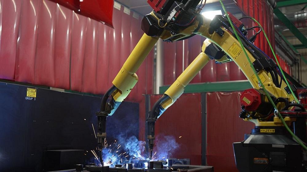 A robotic welding cell is shown.