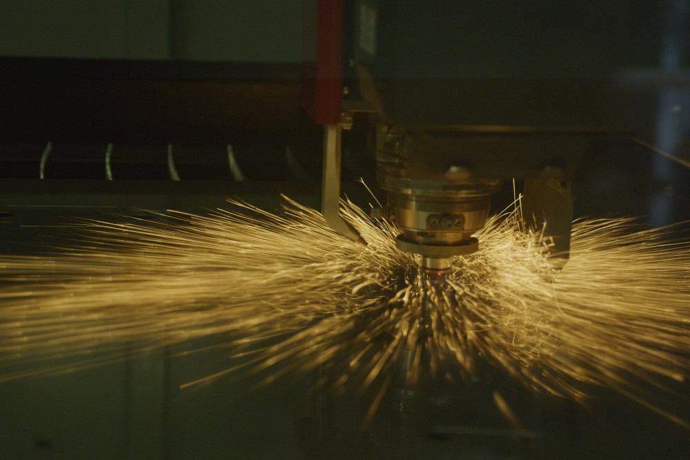 A laser cutting machine pierces a hole.