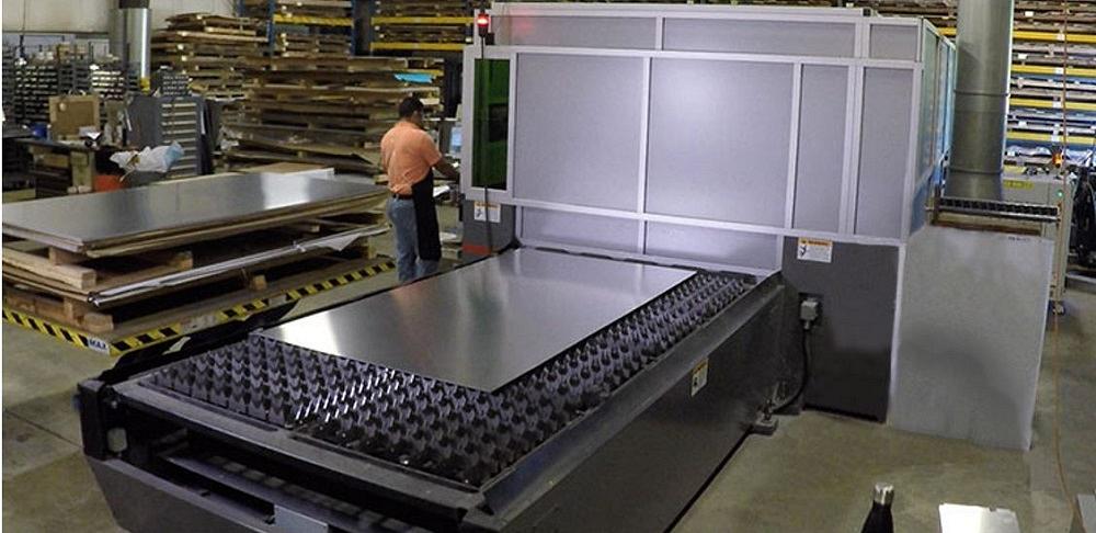 Sheet metal is loaded on a laser cutting machine.