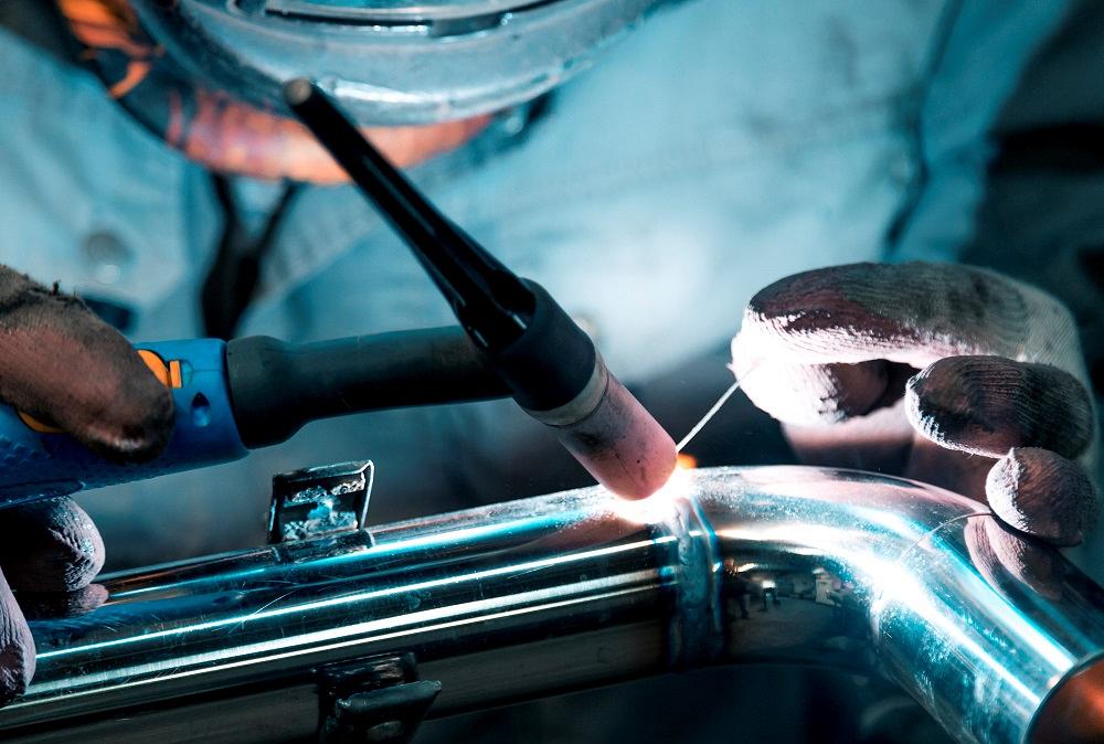 Welder using a TIG process on stainless steel