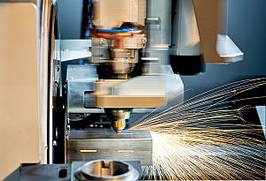 A laser tube cutting machine cuts holes in a square tube.