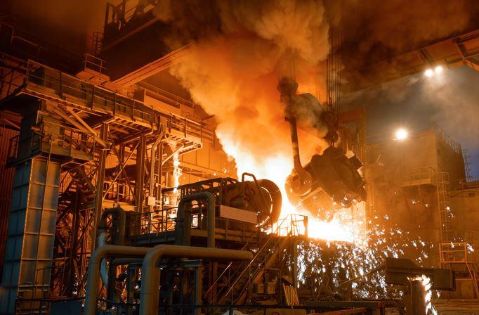 Molten metal is poured into an electric arc furnace for steelmaking.