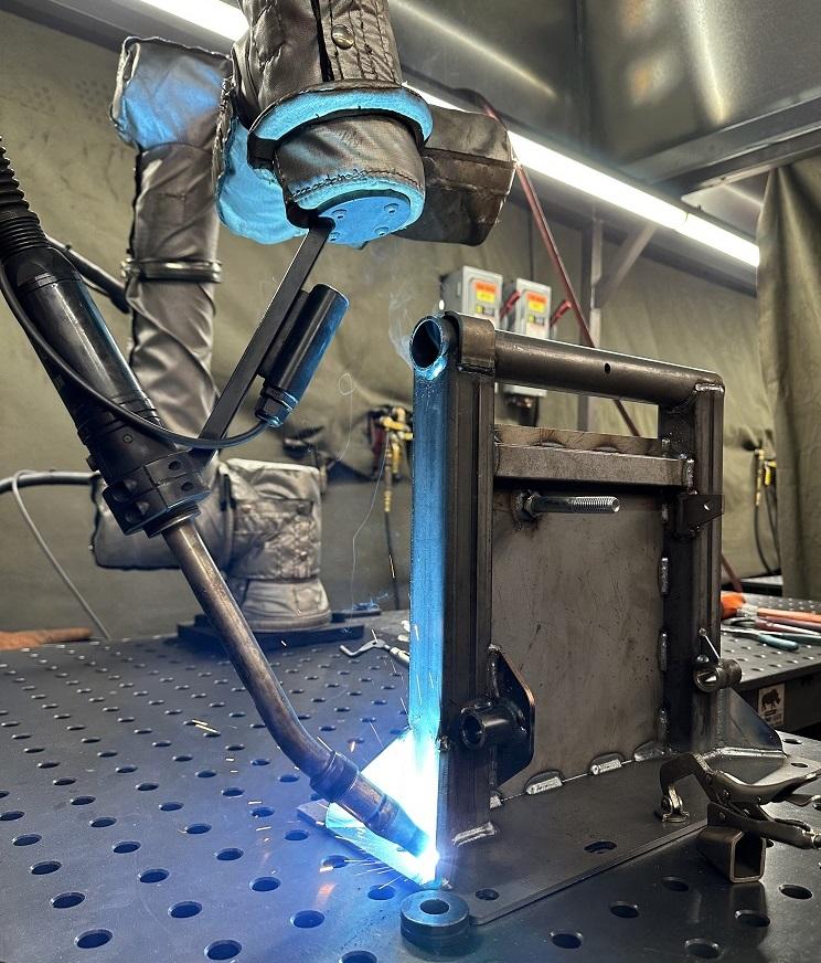 A robot welds a part.