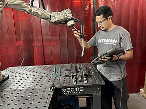 part presentation & lean manufacturing A man positions a cobot.