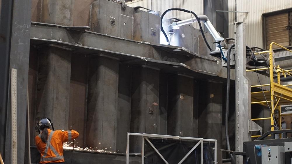 A cobot and a person work close to one another.