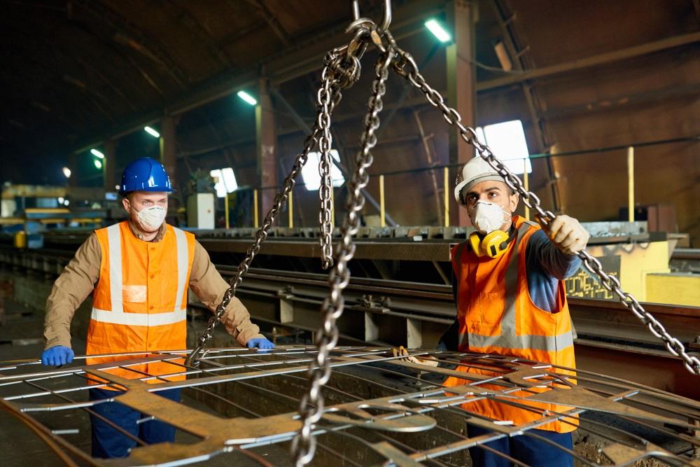 metal fabrication workers wearing PPE