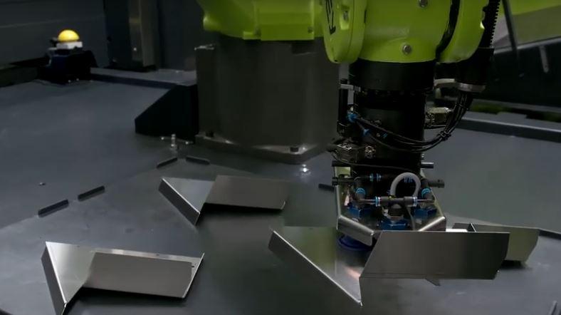 A robot stacks parts.