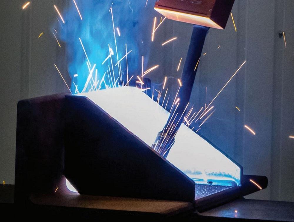 A robot places a weld in a structural steel fabrication.