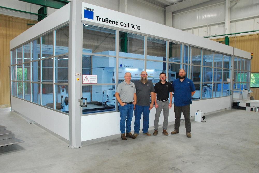 Hickey Metal Fabrication personnel pose in front of an automated bend cell.