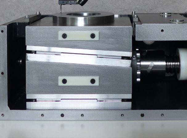 The servomotor-driven sliding wedges of a leveling machine are shown.
