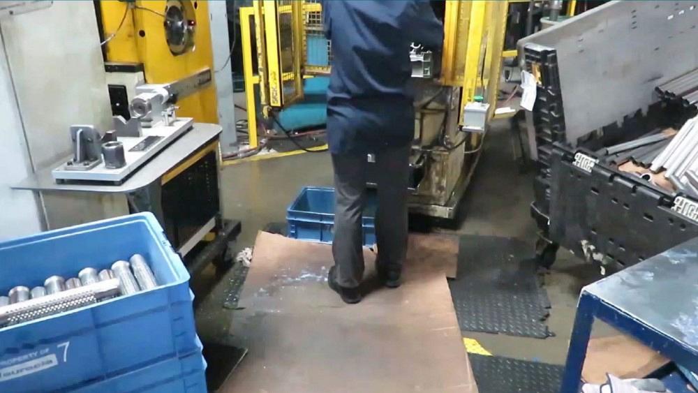 Machine operator is fabricating tube in a workcell.