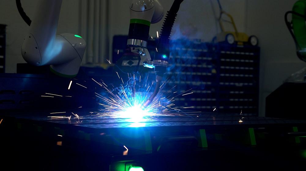 A robot welds a joint.